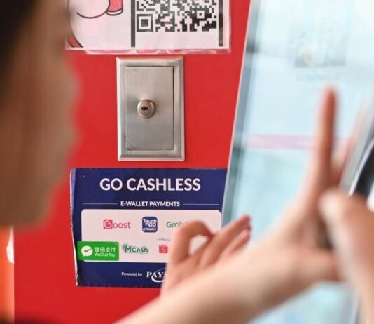 Chiński turysta za granicą płaci tak jak w domu. Azja już to wykorzystuje Tabliczka z logo WeChat Pay i informacją o płatnościach bezgotówkowych w sklepie w Kuala Lumpur w Malezji.
