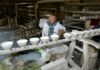 Jingdezhen na Liście UNESCO – tysiąc lat porcelany z gliny, ognia i ludzkiej ręki Rzemieślnik zdobi porcelanowe czarki w tradycyjnym warsztacie w Jingdezhen